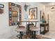 Dining area with eclectic decor, stools and colorful mirror at 1733 Belvidere Rd, Englewood, FL 34223