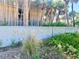 Manasota Beach sign with its tropical landscaped entrance and palms at 1733 Belvidere Rd, Englewood, FL 34223