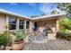 Inviting front porch with tiled landing, blue door, water feature, and lush landscaping at 1733 Belvidere Rd, Englewood, FL 34223