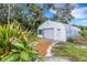 Exterior view of garage featuring a metal roof and well-maintained landscaping at 1733 Belvidere Rd, Englewood, FL 34223