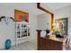Eclectic hallway with decorative furniture, tile floors and artwork at 1733 Belvidere Rd, Englewood, FL 34223