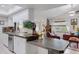 Bright kitchen featuring stainless steel appliances, tile countertops, and a view into the adjacent living area at 1733 Belvidere Rd, Englewood, FL 34223