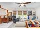 Bright living room featuring natural light, large windows and ceiling fan at 1733 Belvidere Rd, Englewood, FL 34223