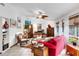 Cozy living room with tile flooring, large windows, and stylish decorative art at 1733 Belvidere Rd, Englewood, FL 34223
