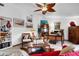 This living room boasts tile flooring, large windows, and decoratively displayed art at 1733 Belvidere Rd, Englewood, FL 34223