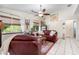 Bright and airy living room featuring large windows, comfortable seating, and an adjacent bedroom at 1733 Belvidere Rd, Englewood, FL 34223