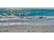 View of the clear turquoise ocean with waves rolling onto the sandy beach at 1733 Belvidere Rd, Englewood, FL 34223