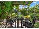 Charming pergola with seating area surrounded by lush greenery in the backyard at 1733 Belvidere Rd, Englewood, FL 34223