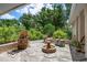 Relaxing outdoor space with a small fountain, decorative plants and a comfortable patio area at 1733 Belvidere Rd, Englewood, FL 34223