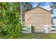 Exterior view of shed featuring crossbuck doors and a white picket fence at 1733 Belvidere Rd, Englewood, FL 34223