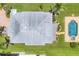 Aerial view of property with a metal roof, pool, and well-manicured lawn at 1784 Bayshore Dr, Englewood, FL 34223