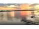 Sunset aerial view of waterfront property featuring dock and tranquil water in a desirable location at 1784 Bayshore Dr, Englewood, FL 34223