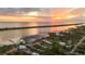 Stunning aerial view of waterfront homes at sunset, showing docks and serene water at 1784 Bayshore Dr, Englewood, FL 34223