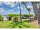 Relaxing hammock under the trees in a peaceful backyard with partial views of the bay at 1784 Bayshore Dr, Englewood, FL 34223