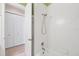 Tiled tub and shower with white tiles, and a view of a nearby linen closet at 1784 Bayshore Dr, Englewood, FL 34223