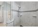 Elegant shower featuring marble tile, a decorative accent border, and a convenient built-in corner seat at 1784 Bayshore Dr, Englewood, FL 34223