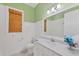 Bathroom featuring a white vanity with marble countertop, beadboard, and a window with woven shades at 1784 Bayshore Dr, Englewood, FL 34223