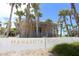 Entrance to Manasota Beach surrounded by lush palm trees at 1784 Bayshore Dr, Englewood, FL 34223
