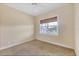 Neutral bedroom featuring a woven shade covered window, carpeted floors and baseboard at 1784 Bayshore Dr, Englewood, FL 34223