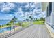 The deck overlooks a beautiful view of the water, the pool, and a perfectly manicured lawn at 1784 Bayshore Dr, Englewood, FL 34223