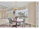 Charming dining area with a bay window, elegant lighting, and a serene water view at 1784 Bayshore Dr, Englewood, FL 34223