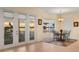 Dining room boasts water views with door to balcony, and round dining table in a sunny setting at 1784 Bayshore Dr, Englewood, FL 34223