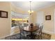 Bright dining area with a bay window overlooking the water and a charming round wooden table at 1784 Bayshore Dr, Englewood, FL 34223