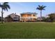 Charming waterfront home with fenced yard, lush green grass, and a serene backyard pool view at 1784 Bayshore Dr, Englewood, FL 34223