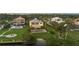 Beautiful waterfront property with lush green lawn, pool, and tropical landscaping at 1784 Bayshore Dr, Englewood, FL 34223