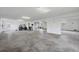 Expansive garage with ample lighting, concrete floors and plenty of room for parking and storage at 1784 Bayshore Dr, Englewood, FL 34223