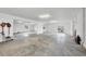 Spacious garage with abundant lighting, concrete floors, and a sliding door to the outside at 1784 Bayshore Dr, Englewood, FL 34223