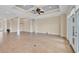Large open space with high ceilings, tile floors, and expansive windows offering abundant natural light at 1784 Bayshore Dr, Englewood, FL 34223