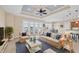 Open living room featuring neutral tones, accent pillows, ceiling fan, and water view at 1784 Bayshore Dr, Englewood, FL 34223