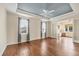 Spacious main bedroom featuring a tray ceiling, wood floors, and lots of natural light at 1784 Bayshore Dr, Englewood, FL 34223