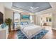 Bright primary bedroom boasts a blue ceiling, ceiling fan, and accent colors at 1784 Bayshore Dr, Englewood, FL 34223