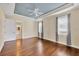 Spacious main bedroom featuring a tray ceiling, wood floors and a bathroom at 1784 Bayshore Dr, Englewood, FL 34223