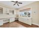 Office featuring custom cabinets, wood floors and a ceiling fan at 1784 Bayshore Dr, Englewood, FL 34223