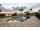 Inviting pool and spa area with a paver surround, palm trees, and views of the tranquil waterfront at 1784 Bayshore Dr, Englewood, FL 34223