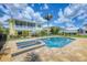 Inviting pool and spa with brick surround, set against the backdrop of a charming yellow two-story home at 1784 Bayshore Dr, Englewood, FL 34223
