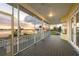 Spacious screened porch with sunset views, a ceiling fan, and a glimpse of the waterfront at 1784 Bayshore Dr, Englewood, FL 34223