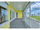 Covered porch with ceiling fans and an expansive view of the beautifully maintained grounds at 1784 Bayshore Dr, Englewood, FL 34223