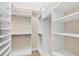 Spacious walk-in closet with built-in shelving and hanging rods at 1784 Bayshore Dr, Englewood, FL 34223