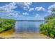 Picturesque waterfront view with sandy beach and clear water at 1784 Bayshore Dr, Englewood, FL 34223
