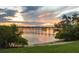 Sunset at the lake creates a tranquil waterfront view at 1784 Bayshore Dr, Englewood, FL 34223