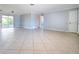 Spacious open living area with tiled floors and sliding glass doors at 1785 Morning Dove Ln, Englewood, FL 34224