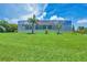 The home boasts a large backyard with a well-manicured lawn and a screened-in lanai at 200 Arlington Dr, Placida, FL 33946