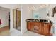 Bathroom featuring a glass-enclosed shower, double sink vanity, and a walk-in closet for plenty of storage at 200 Arlington Dr, Placida, FL 33946