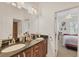 Elegant bathroom featuring a dual sink vanity with granite countertop and decorative lighting fixtures at 200 Arlington Dr, Placida, FL 33946