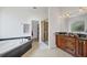 Bathroom with a soaking tub and a glass enclosed shower, alongside a granite double vanity with plenty of counter space at 200 Arlington Dr, Placida, FL 33946