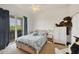 Cozy bedroom featuring a sliding door to the balcony, plush carpet, and a playful teddy bear accent for warmth at 200 Arlington Dr, Placida, FL 33946